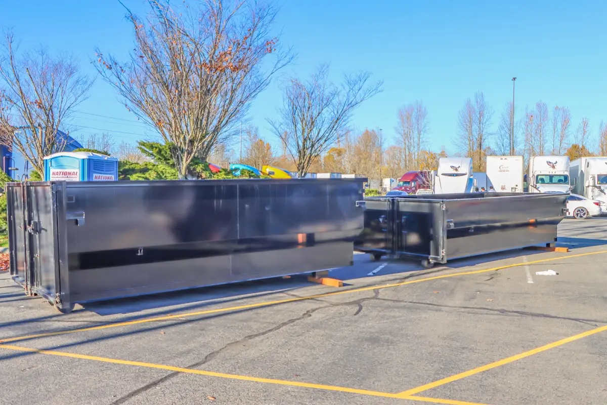 Professional dumpster rental service with roll-off container on residential driveway in Diboll